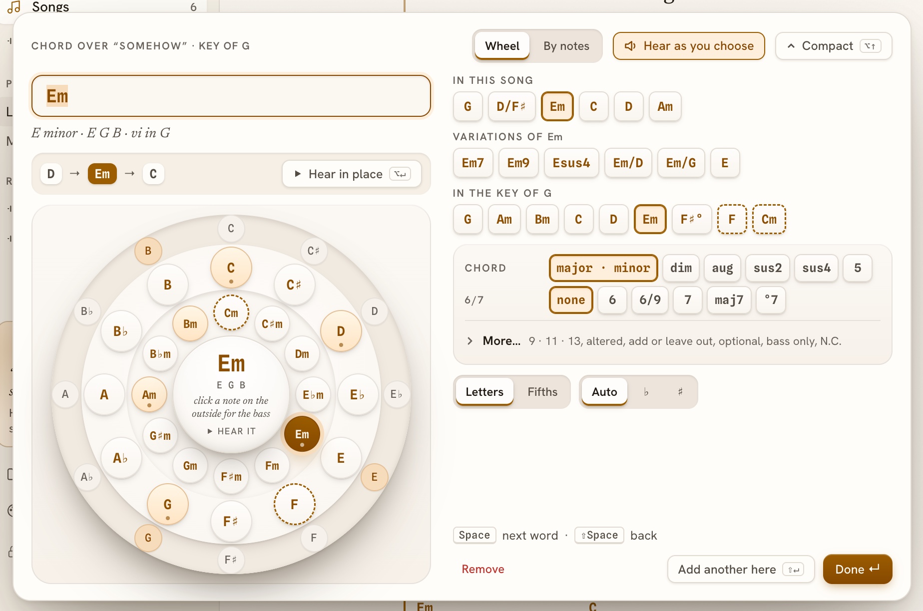The chord wheel open, with Am and its notes in the middle, the chords of G lit, two borrowed chords dashed, and rows of chord types beside it.